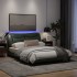 Estructura de cama con luces LED tela gris oscuro 140x200